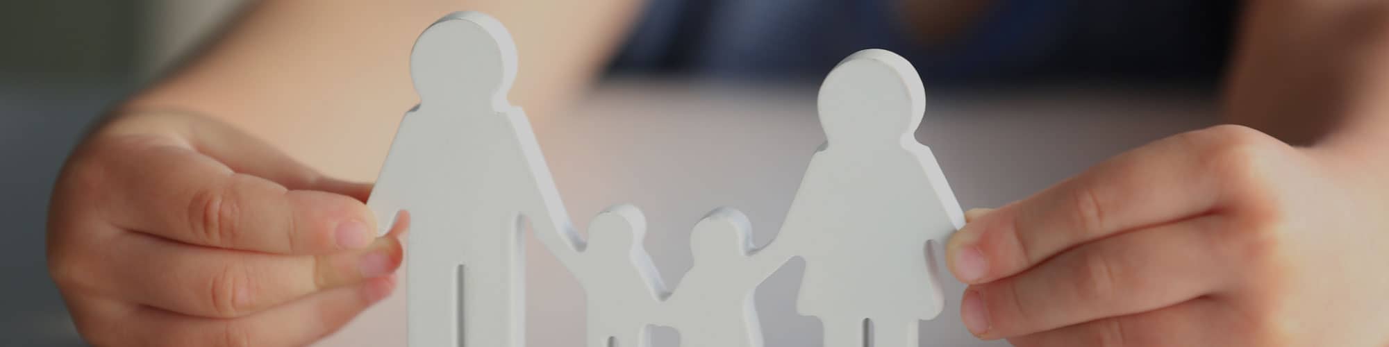 Child holding model of family