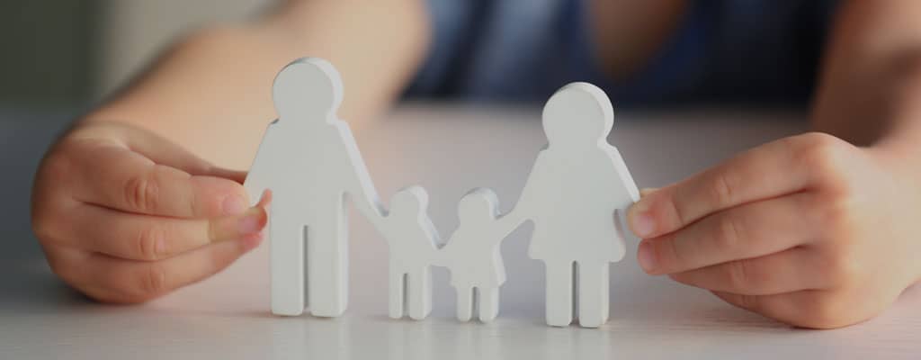 Child holding model of family